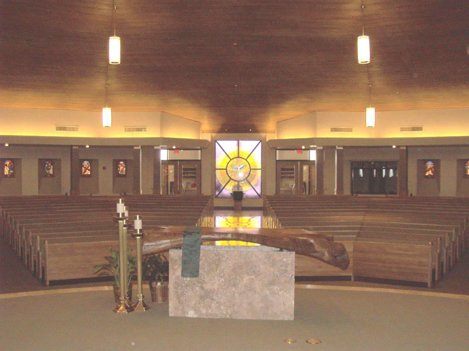 Altar beneath a stained-glass sunburst