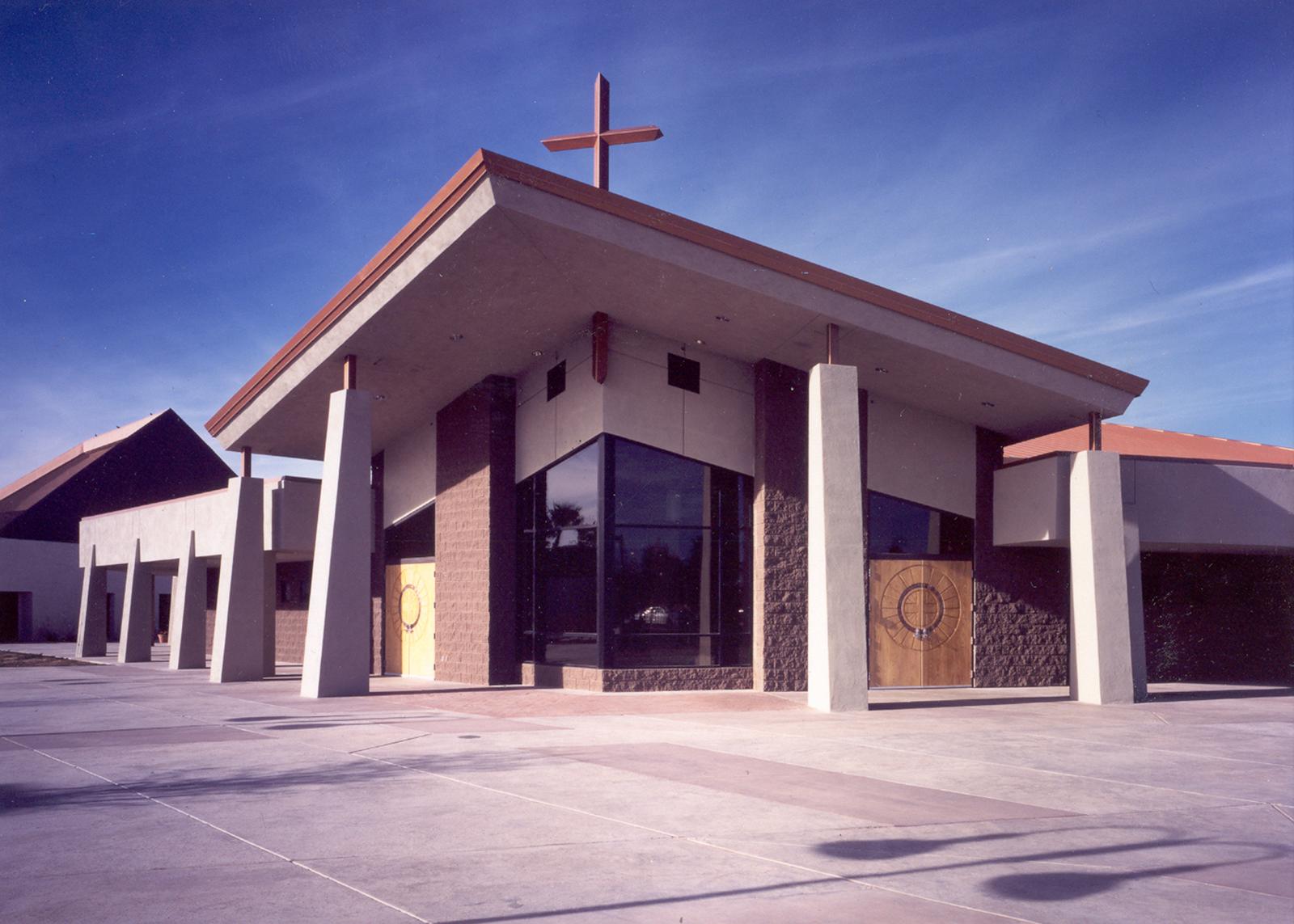 Modern church exterior with angled roof and cross