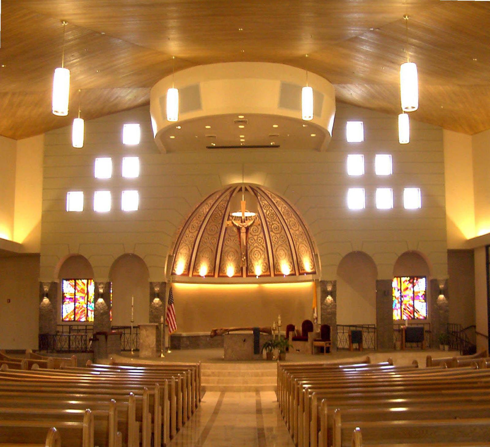 Sanctuary with domed ceiling, pendant lighting, and stained glass