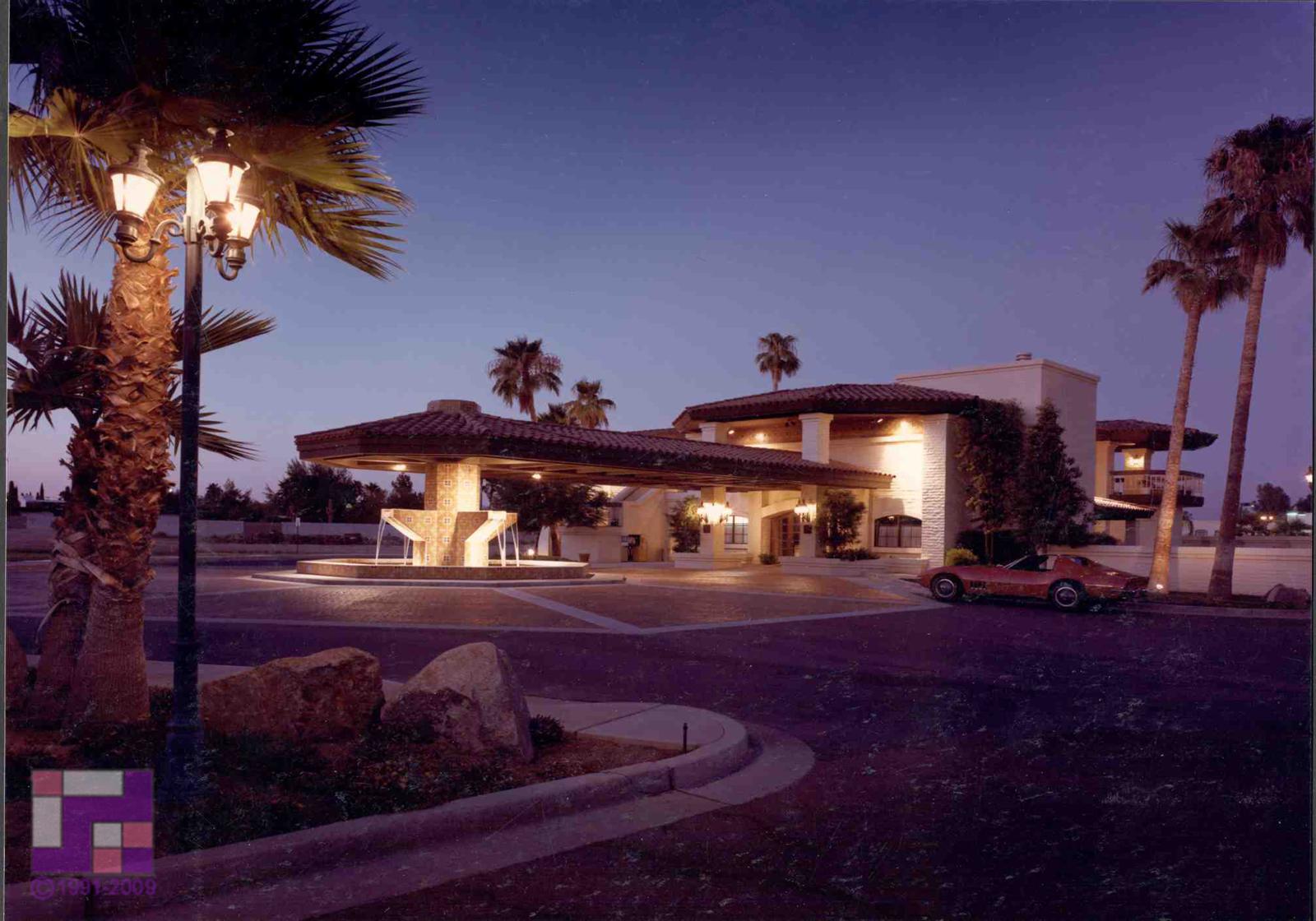 Evening view of a custom resort with palms