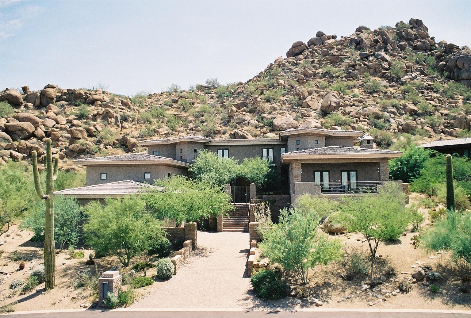 Hillside residence among desert boulders