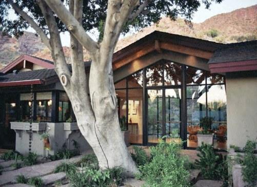 Estate framed by a mature shade tree and lawn