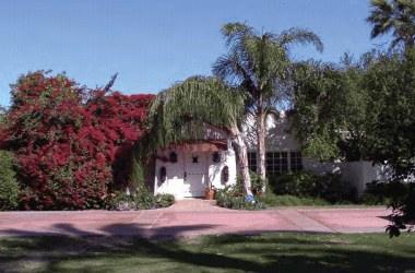 White stucco residence wrapping a pool courtyard